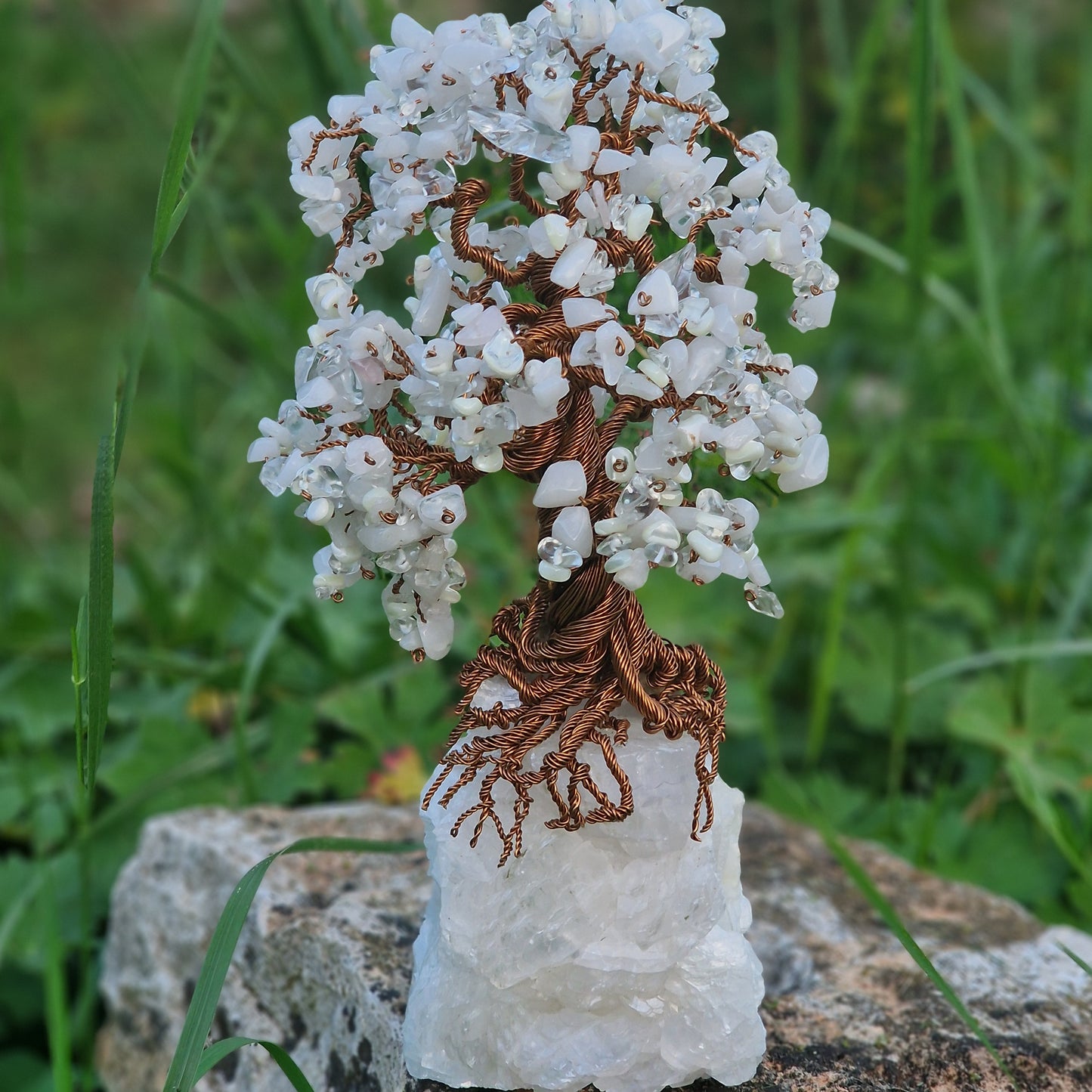 Handcrafted Tree of Life sculpture made with mother of pearl, quartz, and clear crystal on a white quartz base – 26 cm tall.